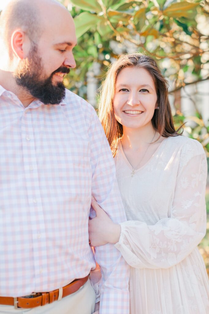 lady in white dress smiling at camera during golden hour