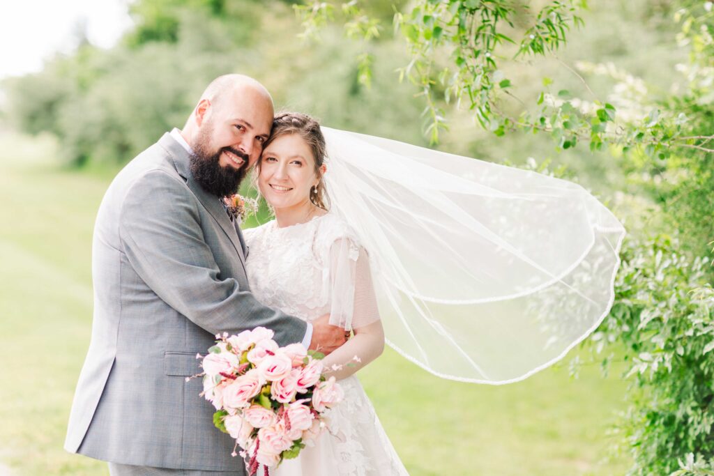 Bride and groom smiling at the camera