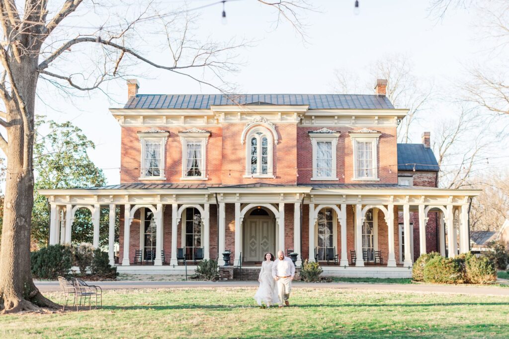 engaged couple running away from Oaklands Mansion just outside of Nashville, TN
