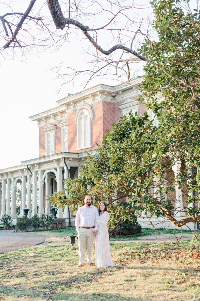 engaged couple standing in front of Oaklands Mansion just outside of Nashville, Tennessee