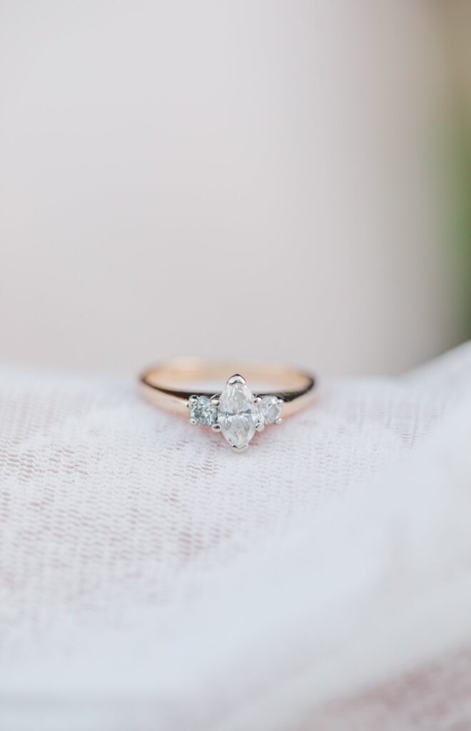 photo of an engagement ring on white cloth