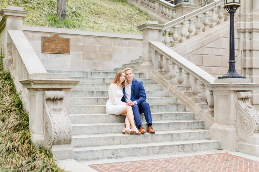 engaged couple sitting on steps in downtown Lynchburg