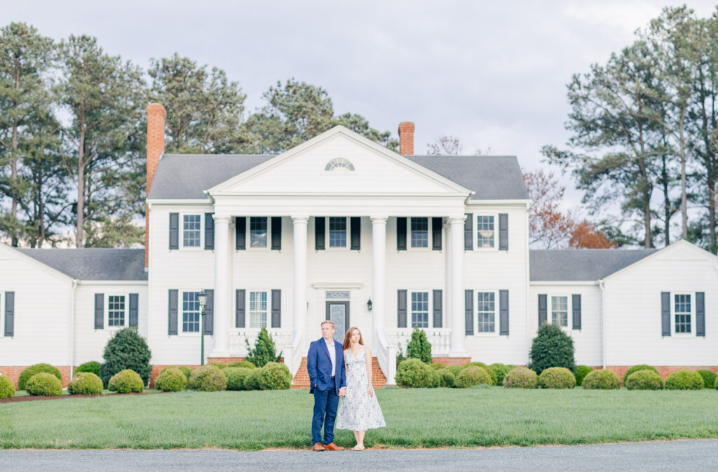 engaged couple standing in front of Spring Grove Ranch in Appomattox, VA