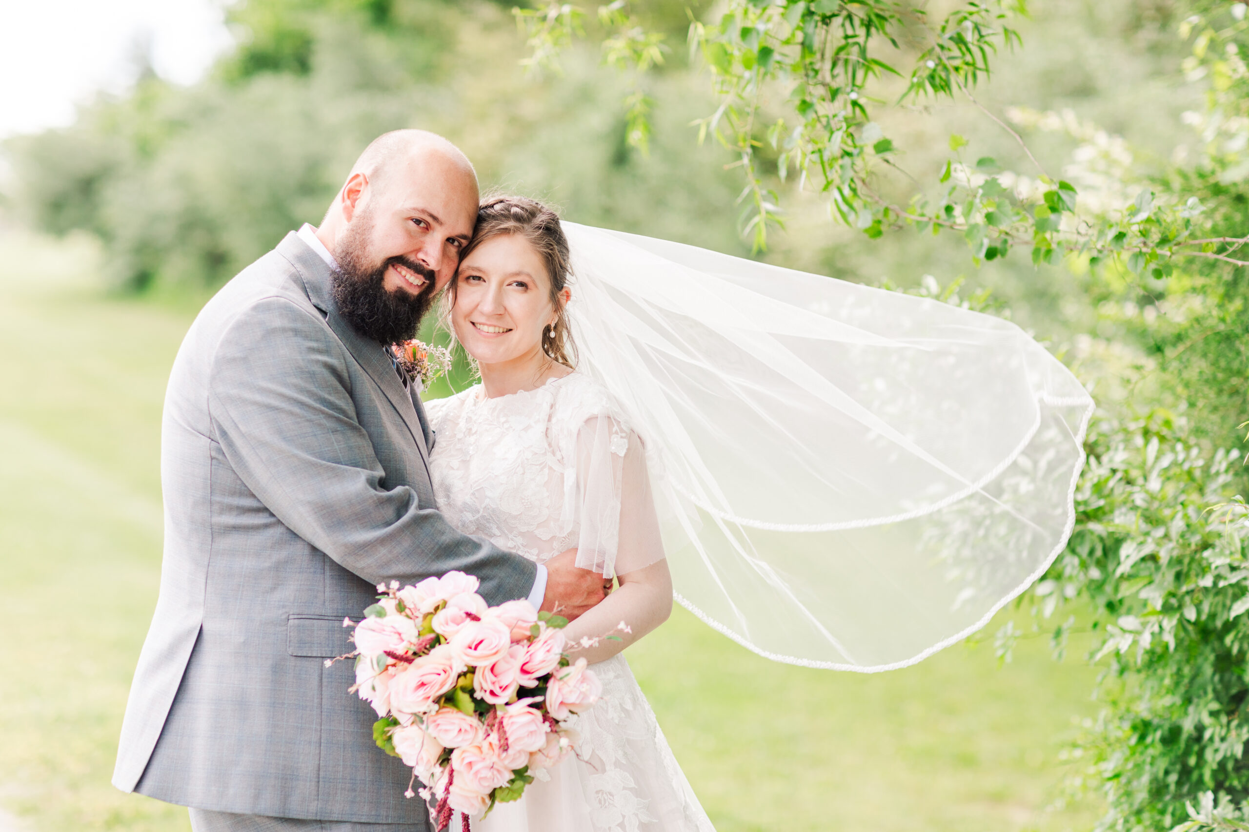 Tennessee Wedding, bride and groom smiling at camera while veil flys