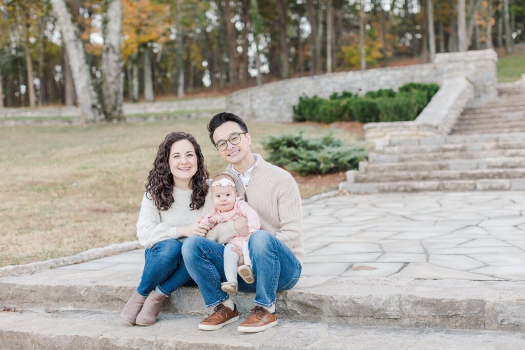 family of three smiling at camera