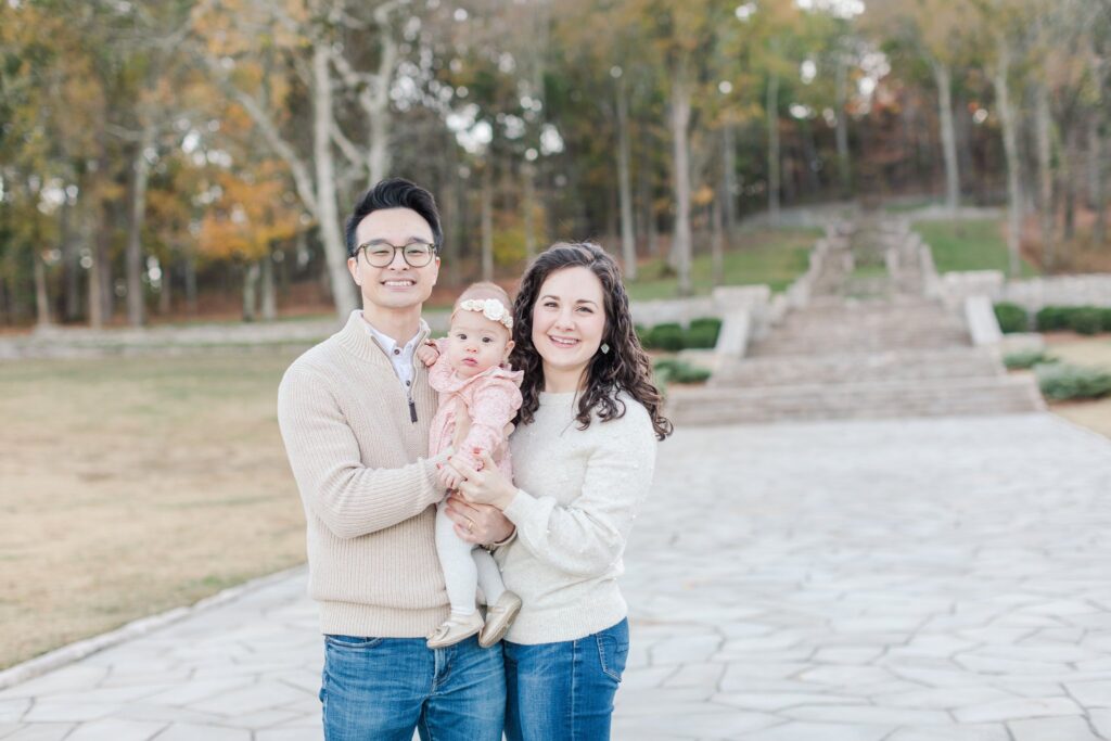 family of three smiling at camera