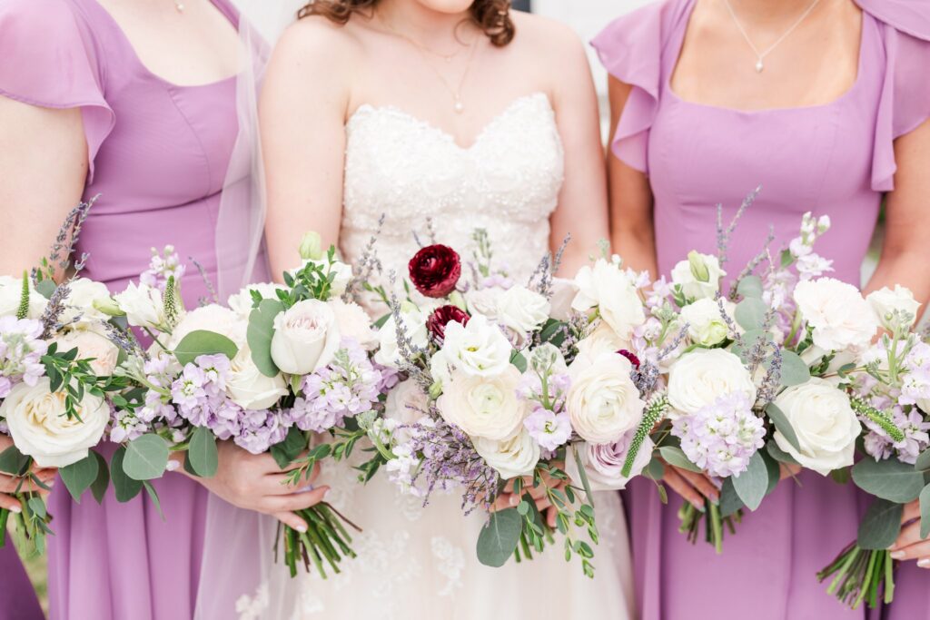 Beautiful bridesmaids holding lavender florals on Jenna's wedding day! Invest in Your Wedding Photographer