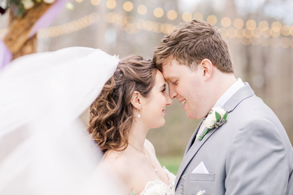 Married couple smiling at each other on their wedding day, Invest in Your Wedding Photographer