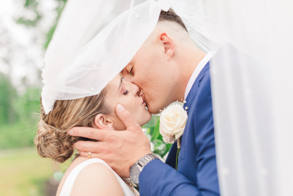 couple kissing underneath wedding veil, Invest in Your Wedding Photographer