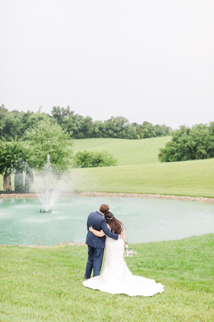 Bride and groom embracing each other photographed by Jennifer Cooke Photography at the White Dove Barn