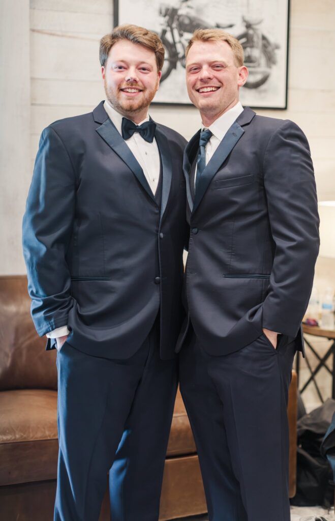 groom and best man posing for a photo in the White Dove Barn Groom's Suite