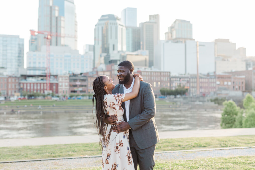 Engaged couple hugging each other at their Nashville Riverfront Engagement Session