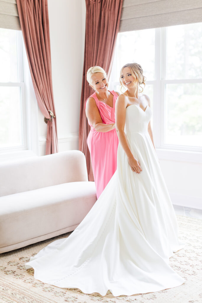 Mother of the bride helping her daughter get ready on her wedding day at Spring Grove Ranch Wedding! 