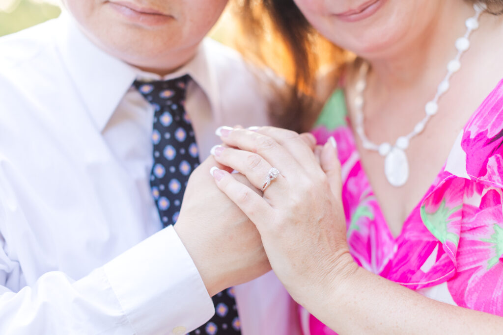 An engaged couple holding hands at Riveredge Park in Madison Heights, VA