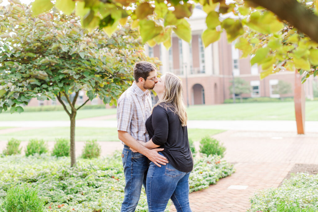 engaged couple at Liberty University kissing in a cute garden